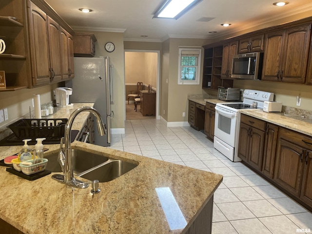 kitchen with open shelves, a sink, appliances with stainless steel finishes, crown molding, and light tile patterned flooring