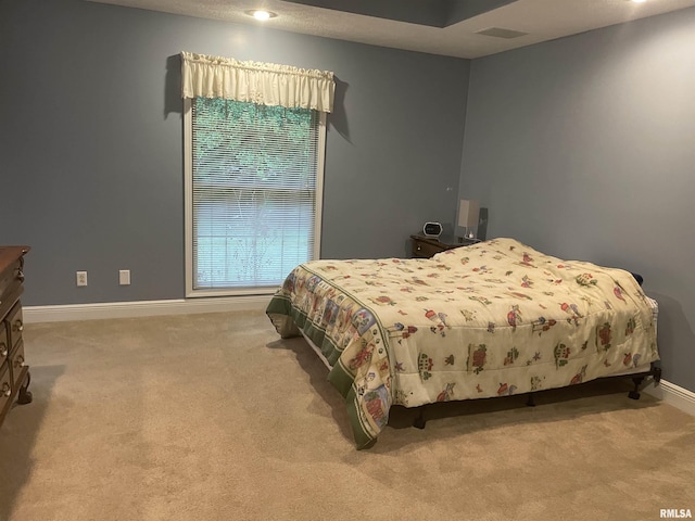 carpeted bedroom with baseboards and visible vents