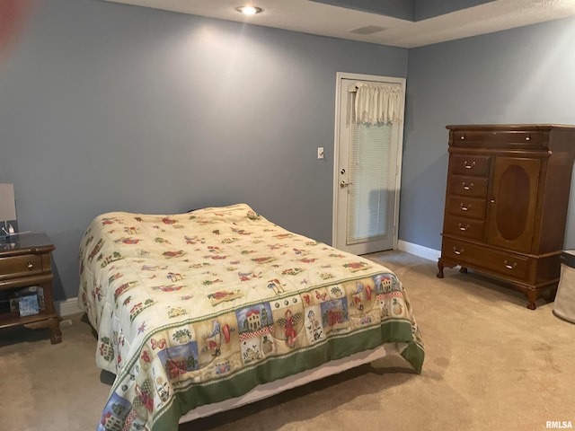 bedroom featuring light colored carpet