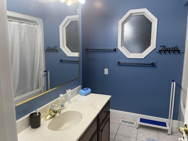 bathroom featuring visible vents, baseboards, vanity, and tile patterned floors