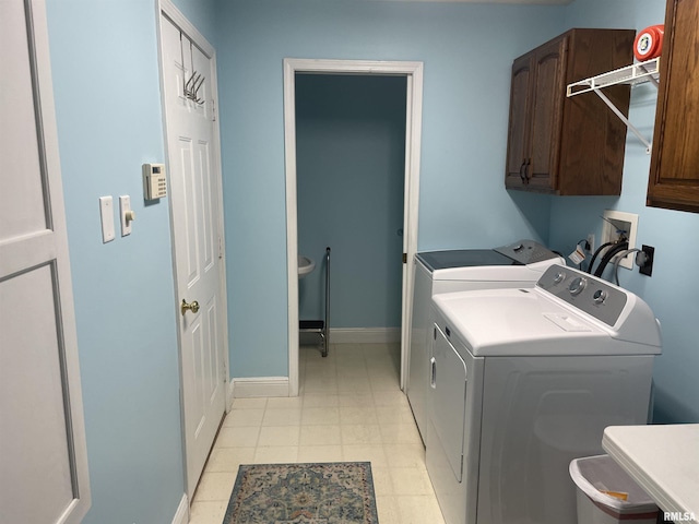 laundry area featuring cabinet space, baseboards, and washer and dryer