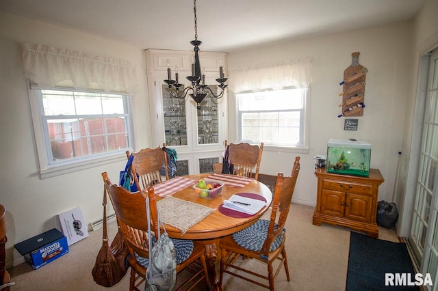 dining area featuring an inviting chandelier and carpet flooring