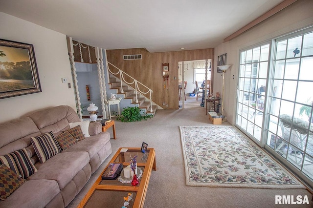 living room with wooden walls and carpet flooring