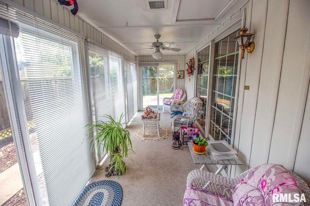 sunroom / solarium featuring ceiling fan