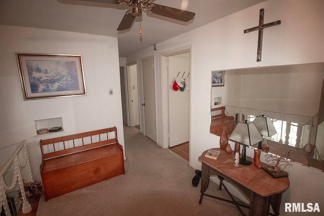 interior space featuring light carpet and ceiling fan