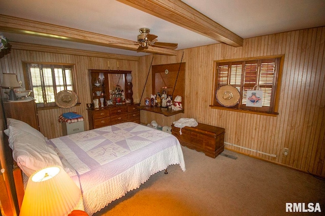 bedroom featuring carpet flooring, wooden walls, ceiling fan, and beamed ceiling