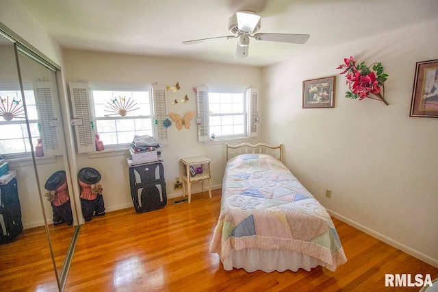 bedroom with ceiling fan, a closet, and hardwood / wood-style floors