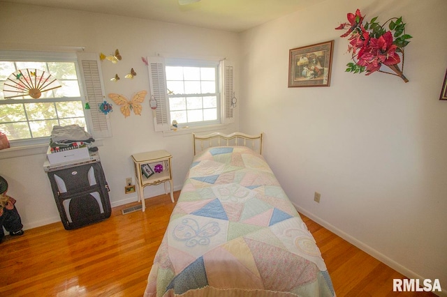 bedroom with wood-type flooring