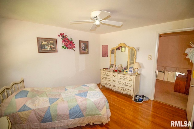 bedroom with ceiling fan and hardwood / wood-style flooring