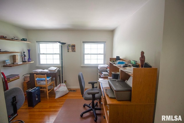 office space with wood-type flooring