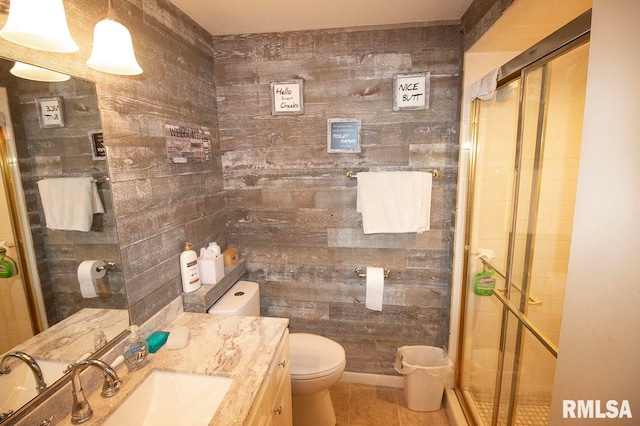 bathroom featuring tile patterned flooring, walk in shower, vanity, and toilet