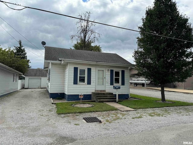 bungalow-style home with a front lawn