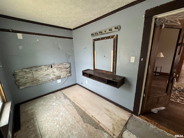 bathroom with a textured ceiling and ornamental molding