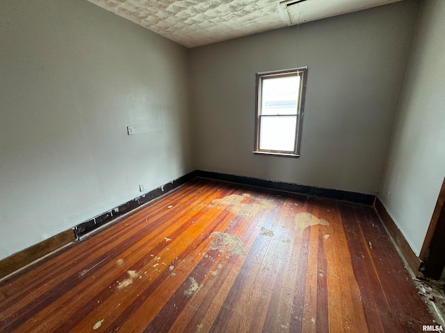 unfurnished room featuring dark hardwood / wood-style flooring