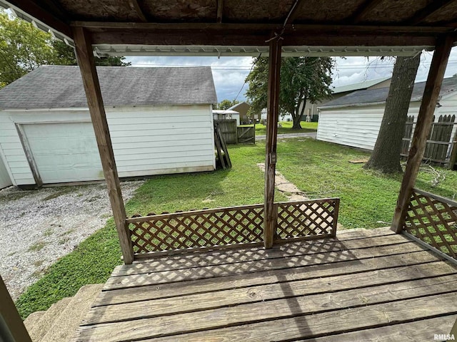 wooden deck with an outdoor structure and a yard