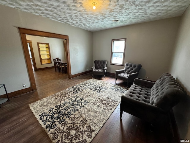 living room featuring hardwood / wood-style flooring and a textured ceiling