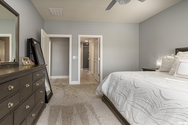 bedroom featuring carpet flooring, ensuite bath, and ceiling fan