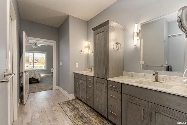 bathroom with ceiling fan, vanity, and hardwood / wood-style flooring