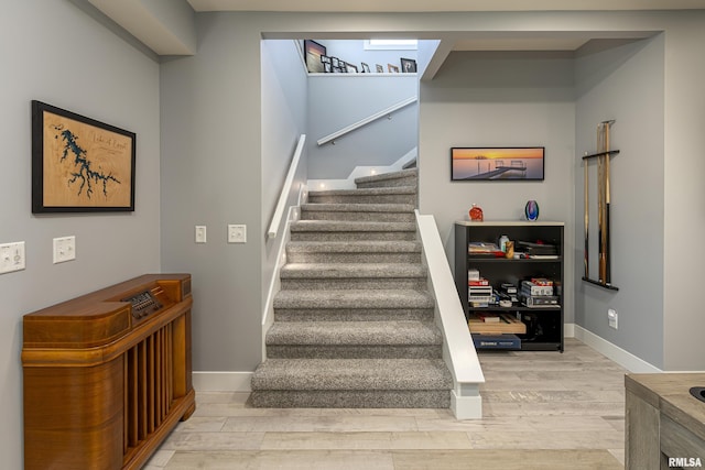 stairway with hardwood / wood-style flooring