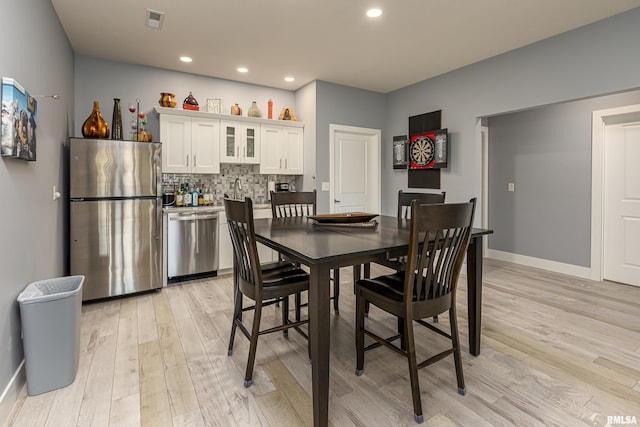 dining area with light hardwood / wood-style floors