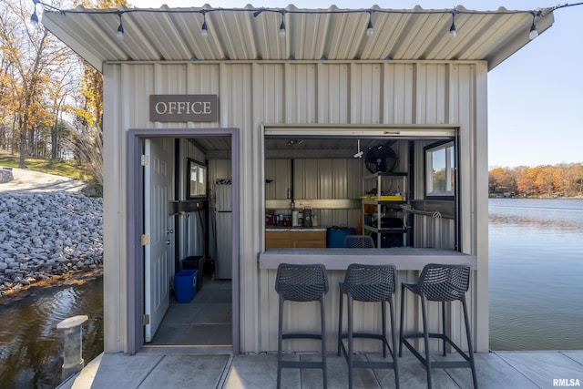 exterior space with a water view and a bar