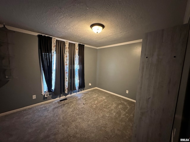 carpeted empty room featuring ornamental molding and a textured ceiling