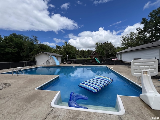 3995 Rte 37, Marion, IL 62959 - view of pool featuring a water slide, a playground, a patio, a shed, and view of wooded area