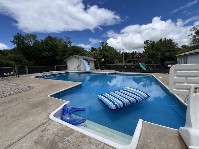 3995 Rte 37, Marion, IL 62959 - view of swimming pool featuring a water slide, a storage shed, a patio, a playground, and view of scattered trees