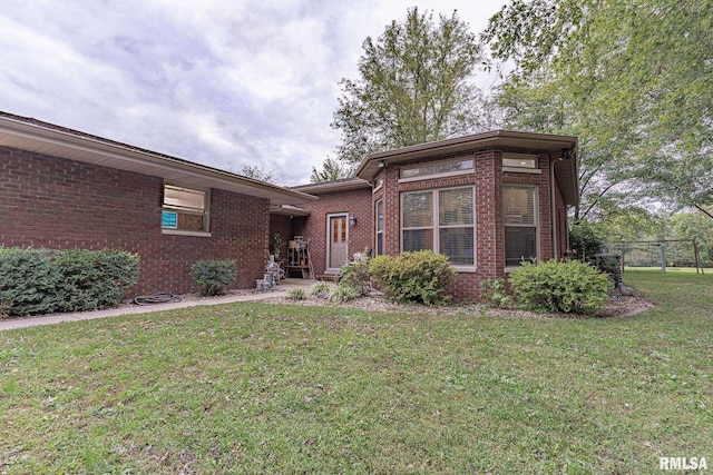 2022 W Main St, Salem, IL 62881 - view of front of house with a front lawn, brick siding, and fence