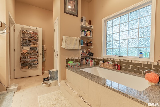 bathroom with radiator, tile patterned floors, and backsplash