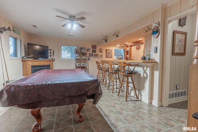 playroom featuring pool table, wooden walls, ornamental molding, indoor bar, and ceiling fan