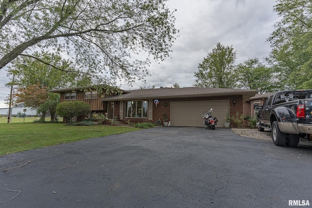 view of front of property with a front yard and a garage