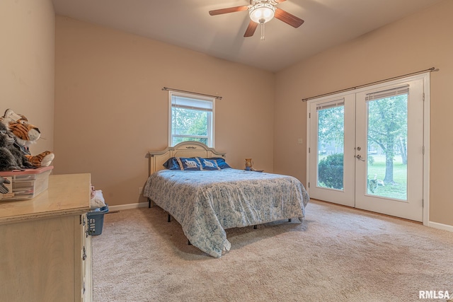 bedroom featuring light carpet, multiple windows, access to outside, and ceiling fan