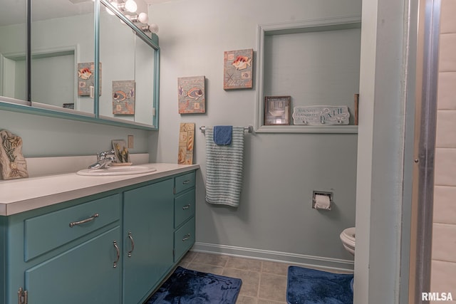 bathroom featuring vanity, toilet, and tile patterned flooring