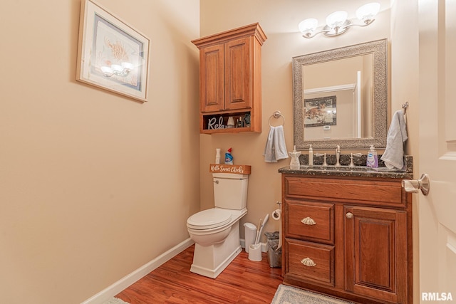 bathroom with vanity, hardwood / wood-style flooring, and toilet