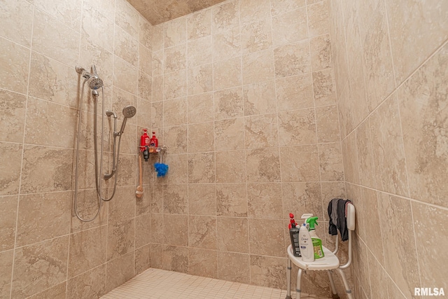 bathroom with a tile shower