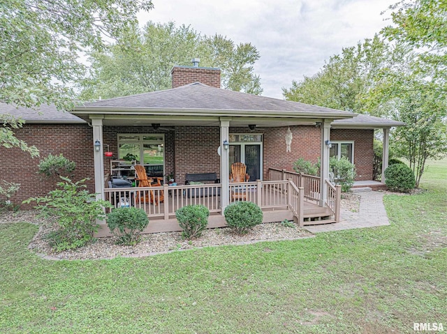 2022 W Main St, Salem, IL 62881 - rear view of house with brick siding, a wooden deck, a chimney, and a lawn