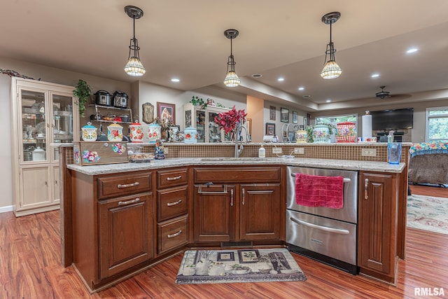 kitchen featuring sink, hanging light fixtures, dark hardwood / wood-style floors, and backsplash