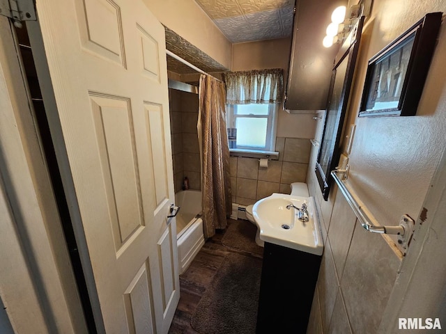 full bathroom featuring vanity, shower / tub combo, hardwood / wood-style flooring, tile walls, and toilet