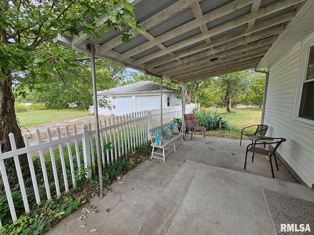 view of patio / terrace with an outdoor structure and a garage