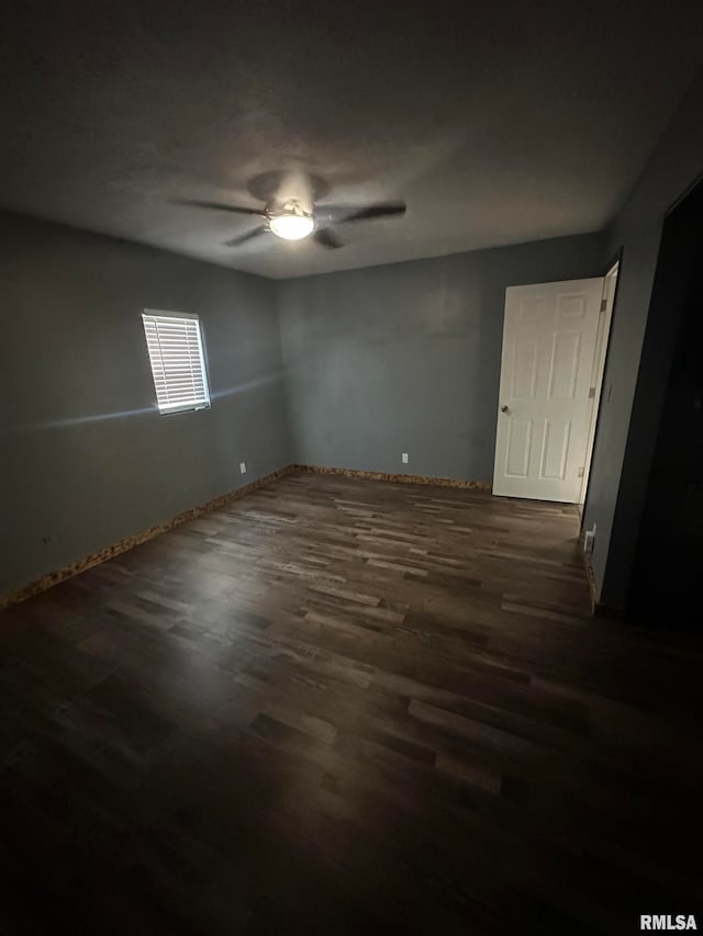 spare room featuring ceiling fan and dark hardwood / wood-style floors