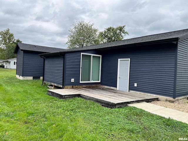 rear view of property featuring a deck and a yard