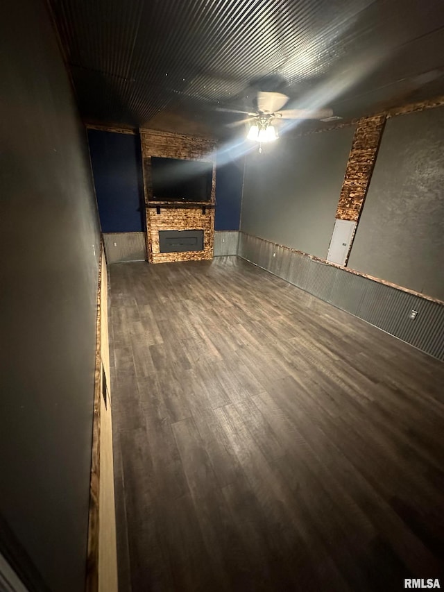 basement featuring ceiling fan and hardwood / wood-style floors