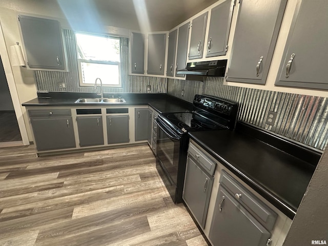 kitchen with gray cabinets, light hardwood / wood-style floors, black / electric stove, and sink