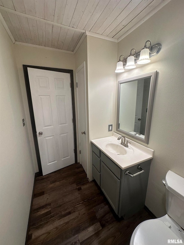 bathroom with hardwood / wood-style floors, wood ceiling, vanity, and toilet