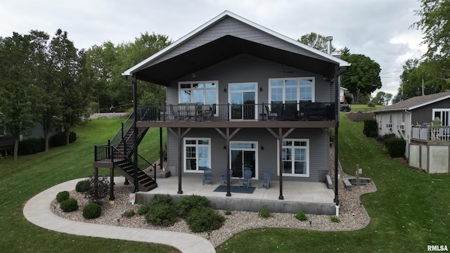 back of property featuring a deck, a yard, and a patio