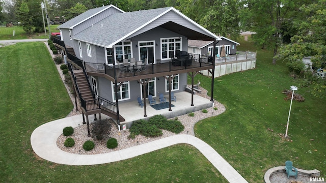 rear view of house featuring a patio area, stairway, and a yard