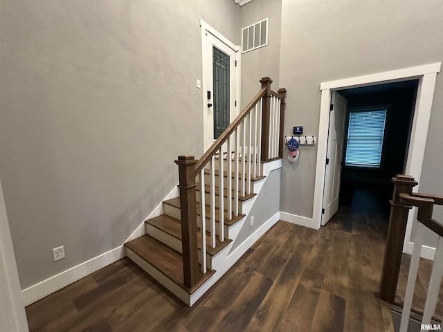 staircase with hardwood / wood-style flooring