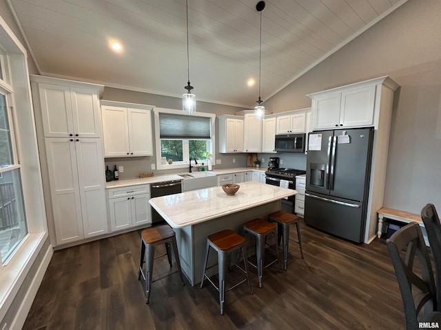 kitchen with lofted ceiling, white cabinetry, dark hardwood / wood-style flooring, and stainless steel appliances