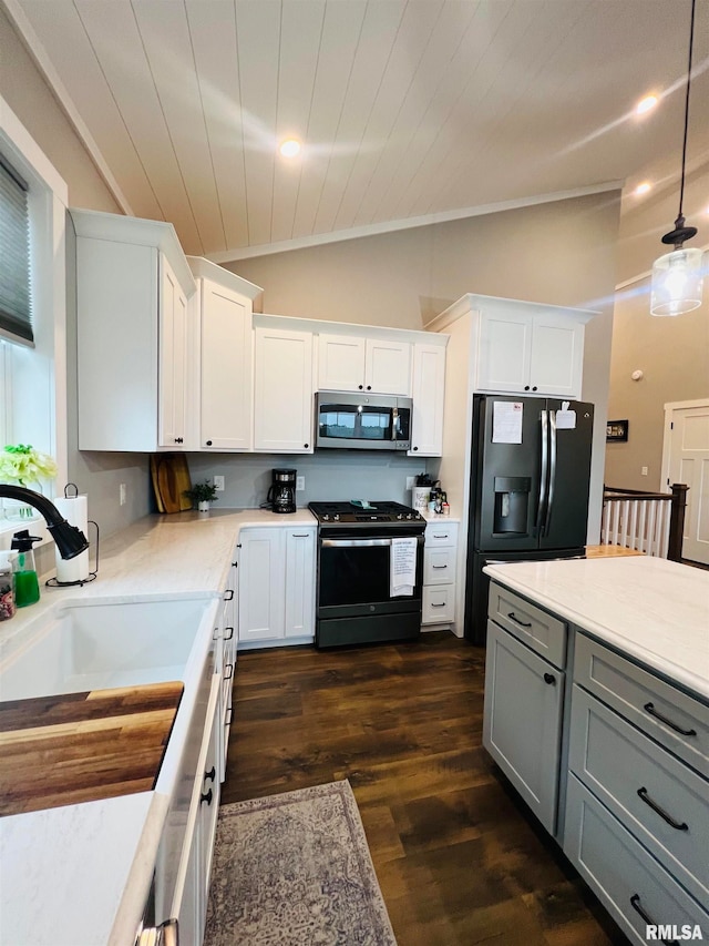 kitchen featuring white cabinetry, vaulted ceiling, dark wood-type flooring, gray cabinets, and stainless steel appliances